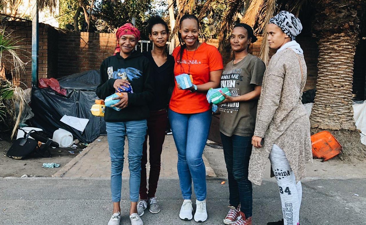 A woman receiving pads and soap from Girls With Wiings